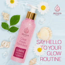 A bottle of Skinora Clear, Fresh, Confident Liminé Radiance Cleanser in pink with a gold pump, styled on a light blue water-textured background with daisies, seashells, and green leaves. Text on the right reads 'SAY HELLO TO YOUR GLOW ROUTINE'.