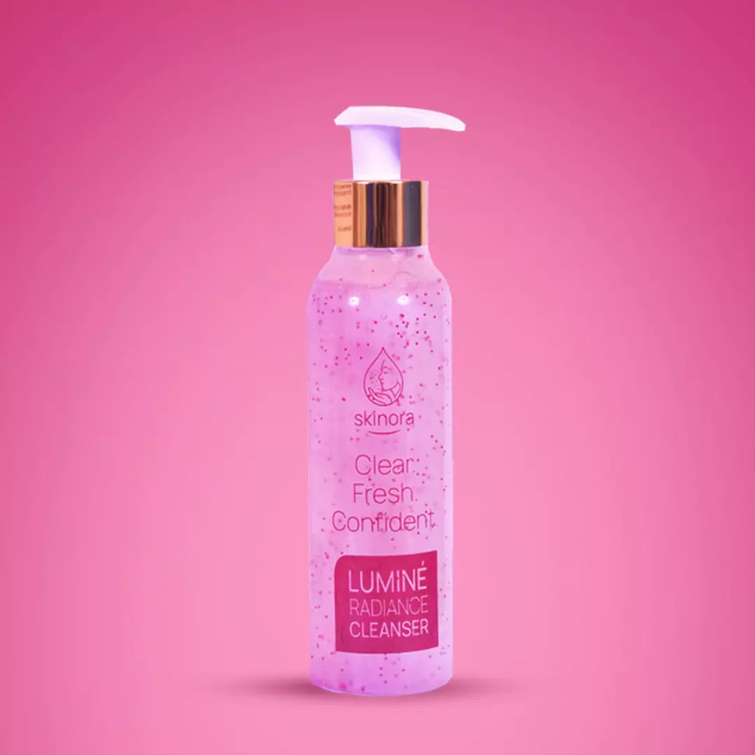 Pink bottle of skincare cleanser with pump on a pink background